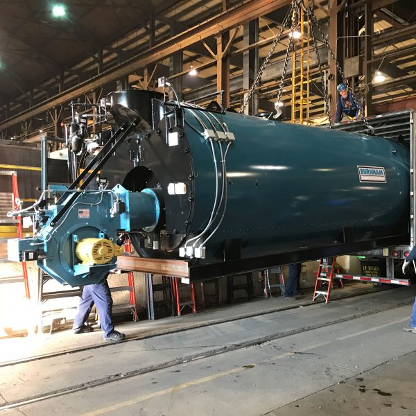 mobile boiler being loaded onto truck for transport