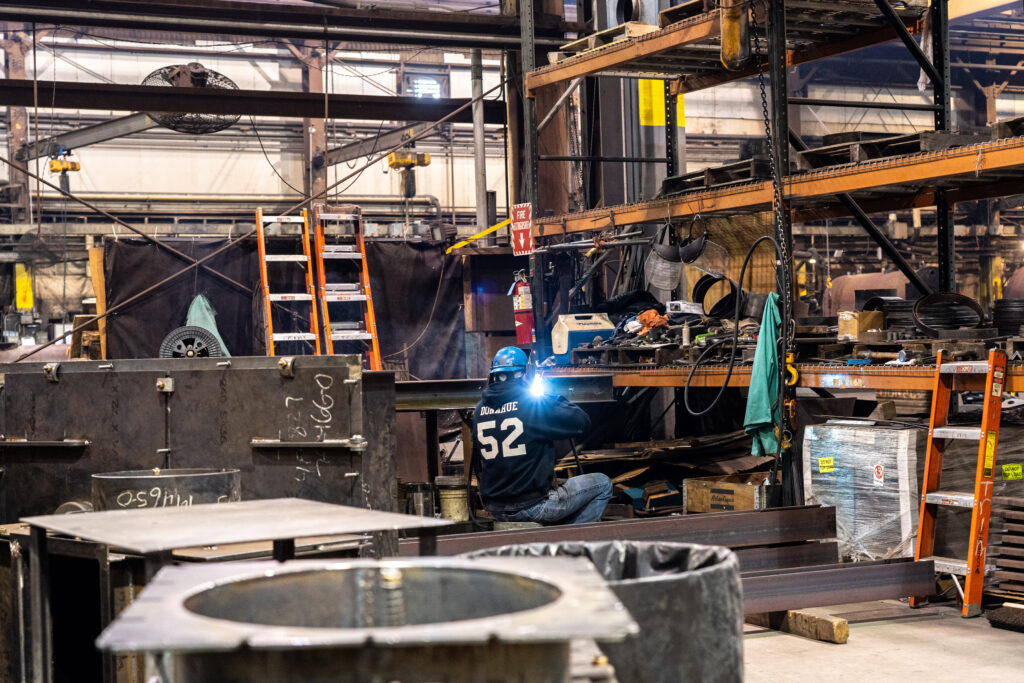 Warehouse worker welding Burnham Commercial Boiler