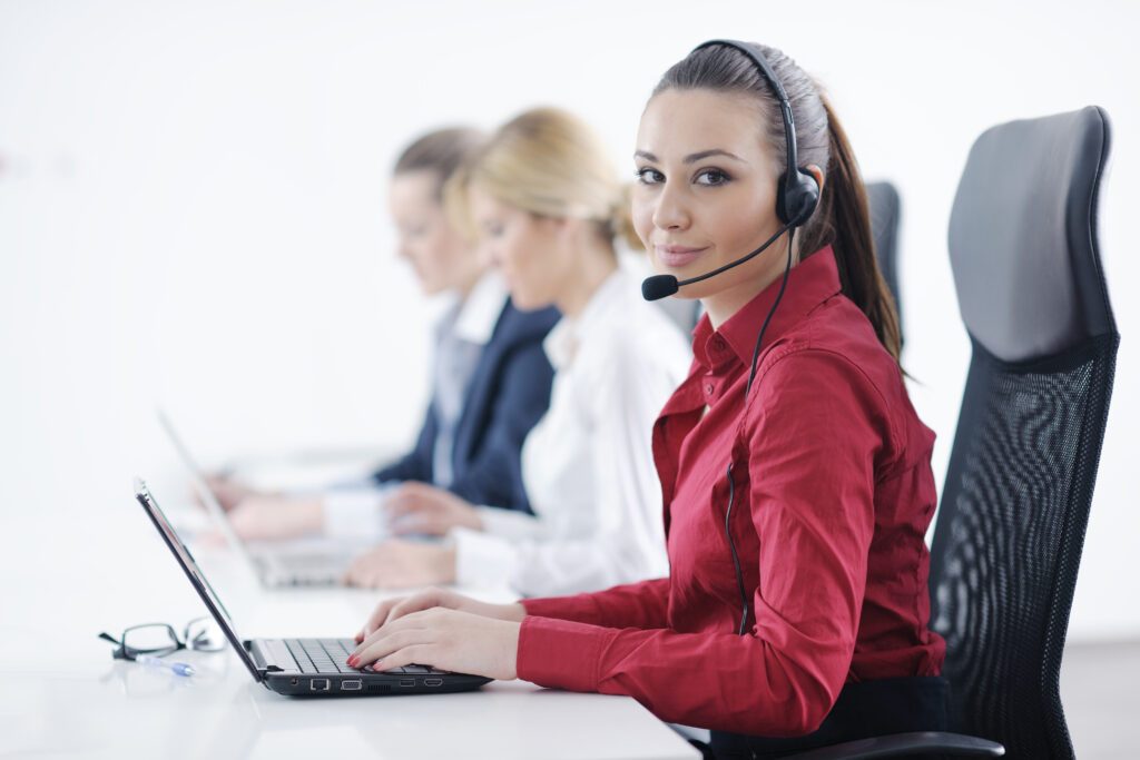 Customer service agents on headsets at desks